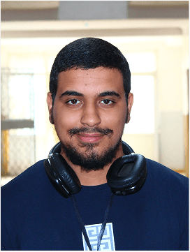 Chouaib wearing headphones at his desk